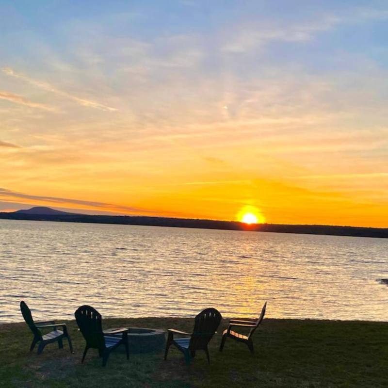 a couple of people that are standing in front of a body of water