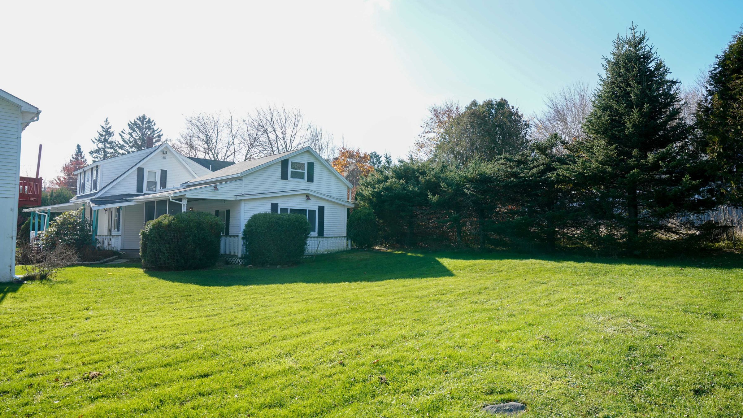 a house in the middle of a lush green field