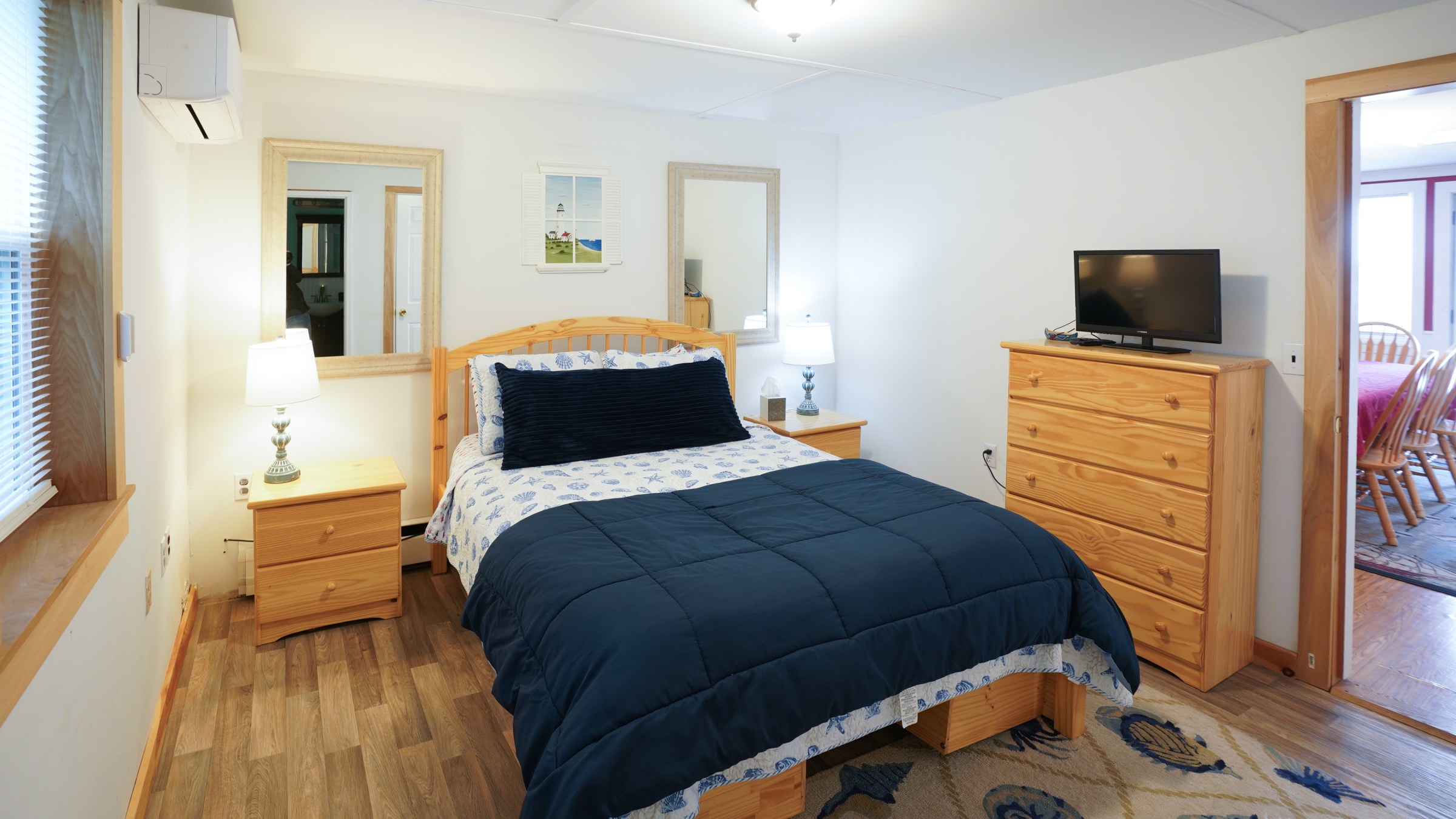 a bedroom with a bed and desk in a room