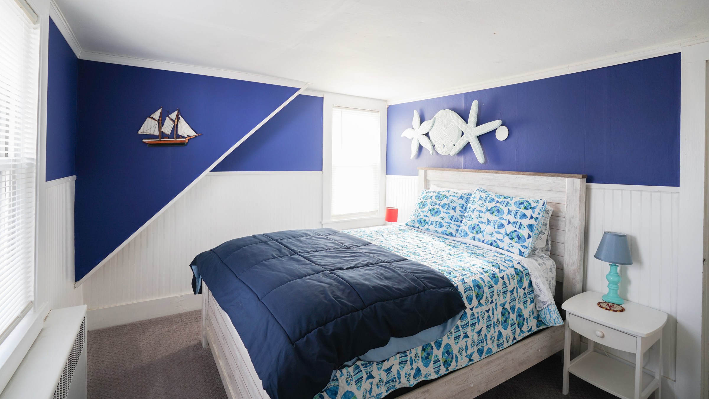 a bedroom with a bed and a blue blanket