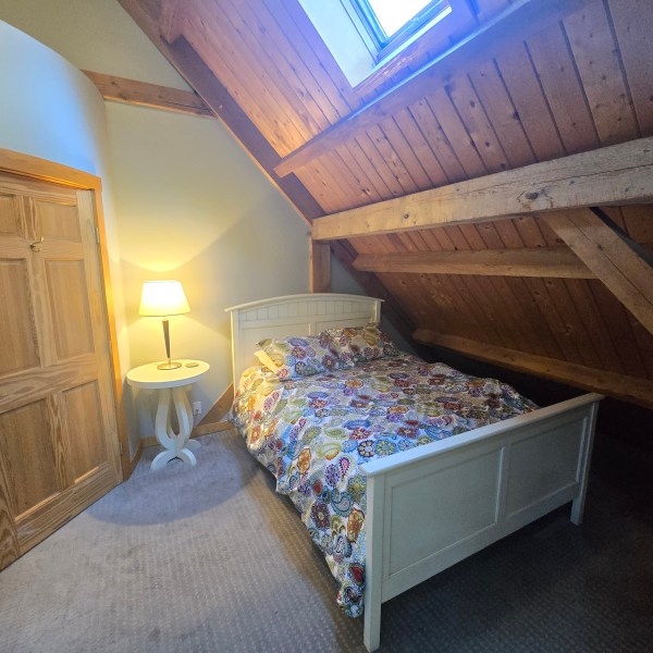 a bedroom with a bed in a room