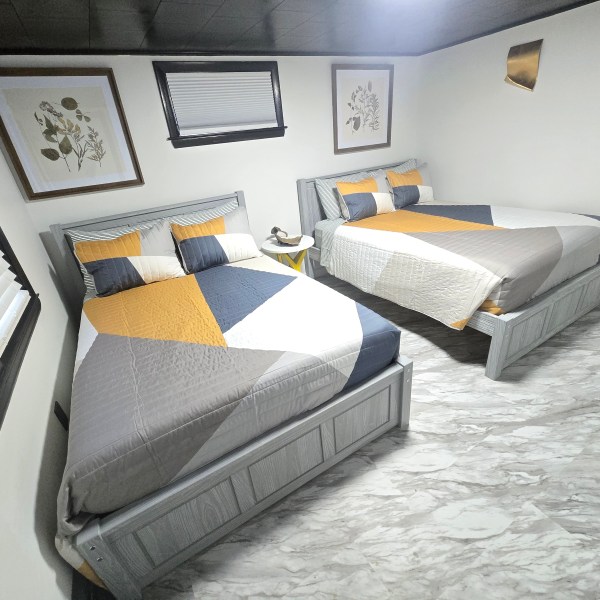 a bedroom with a bed and desk in a room