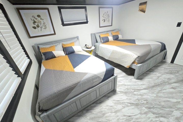 a bedroom with a bed and desk in a room