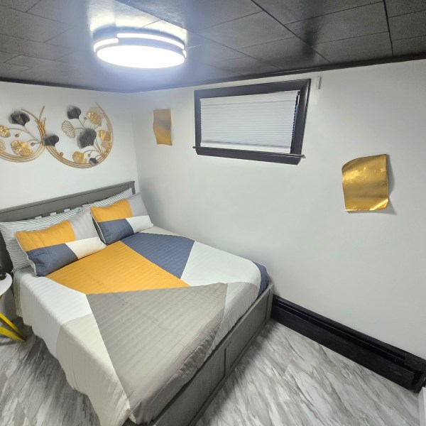 a bedroom with a bed and a mirror