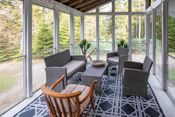 a living room filled with furniture and a large window