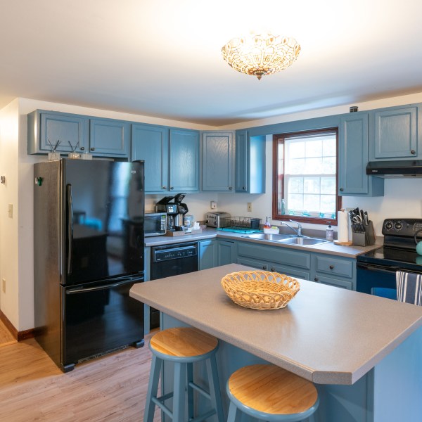 a kitchen with an island in the middle of a room