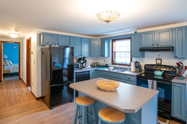 a kitchen with an island in the middle of a room