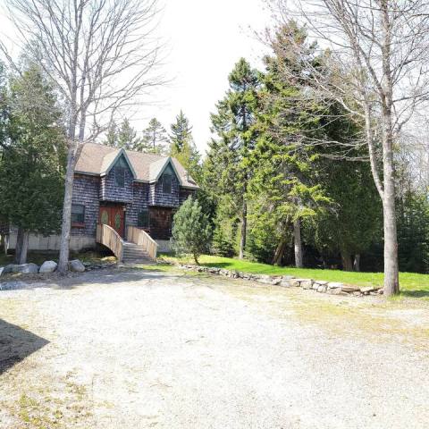 a house with trees in the background