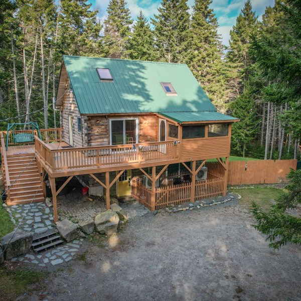 a couple of lawn chairs sitting on top of a wooden house