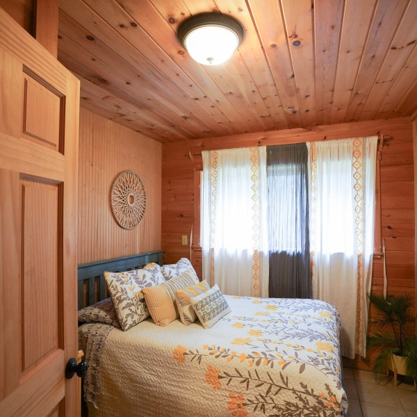 a bedroom with a bed in a room