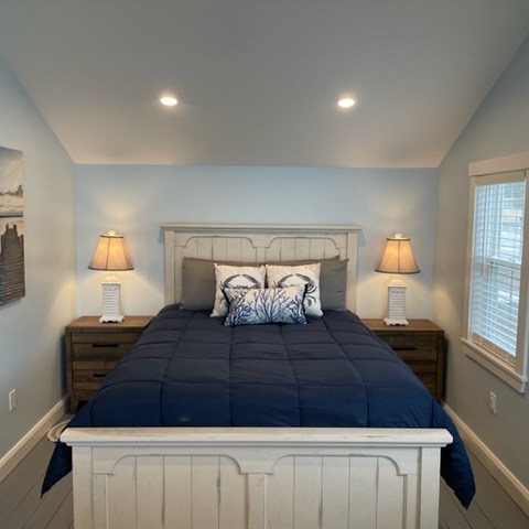 a bedroom with a bed and a mirror