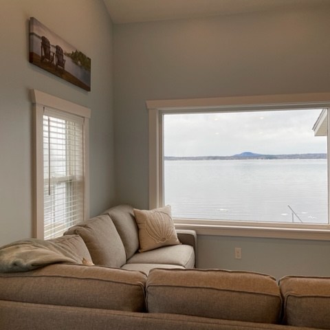 a living room filled with furniture and a large window