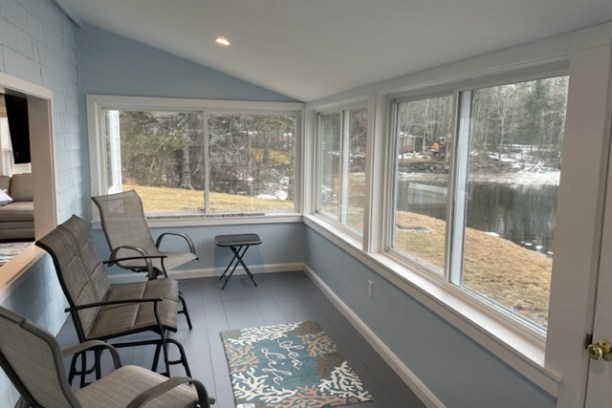 a view of a living room filled with furniture and a large window