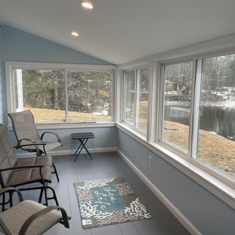 a view of a living room filled with furniture and a large window