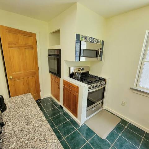 a kitchen with a stove and a sink